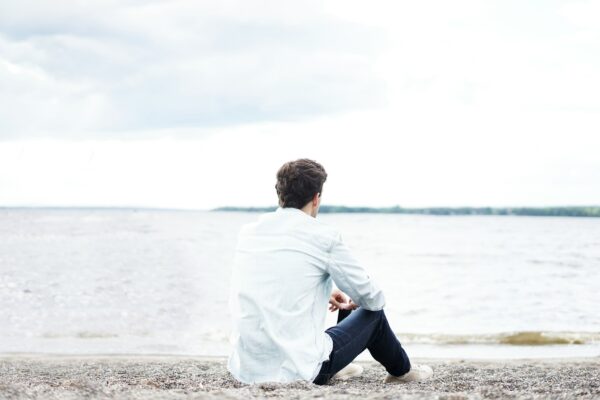 man at peace overlooking shoreline