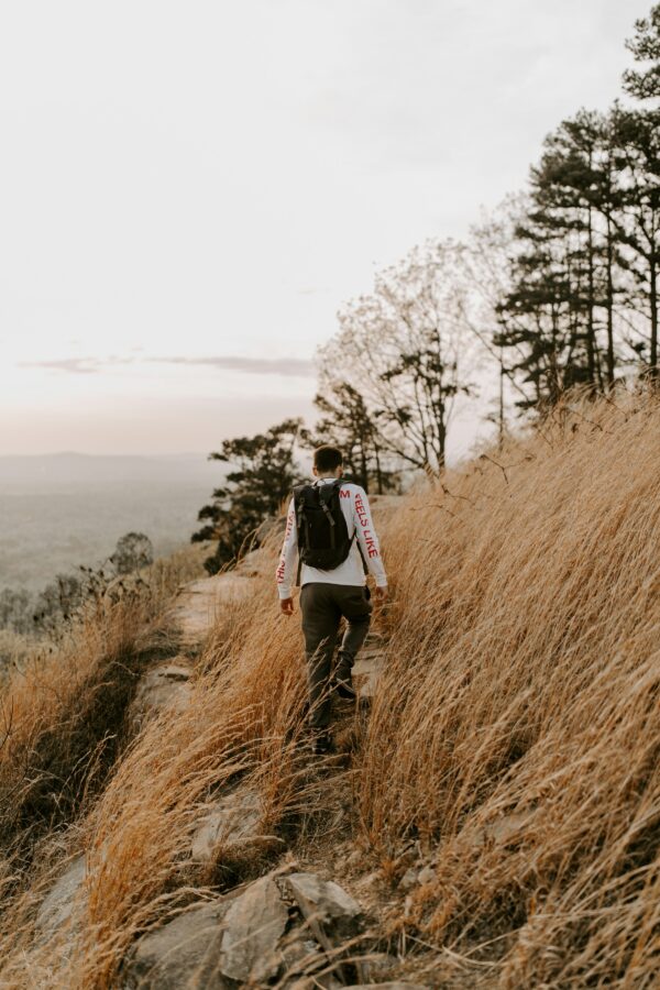 wellthy man walking coastline on life path